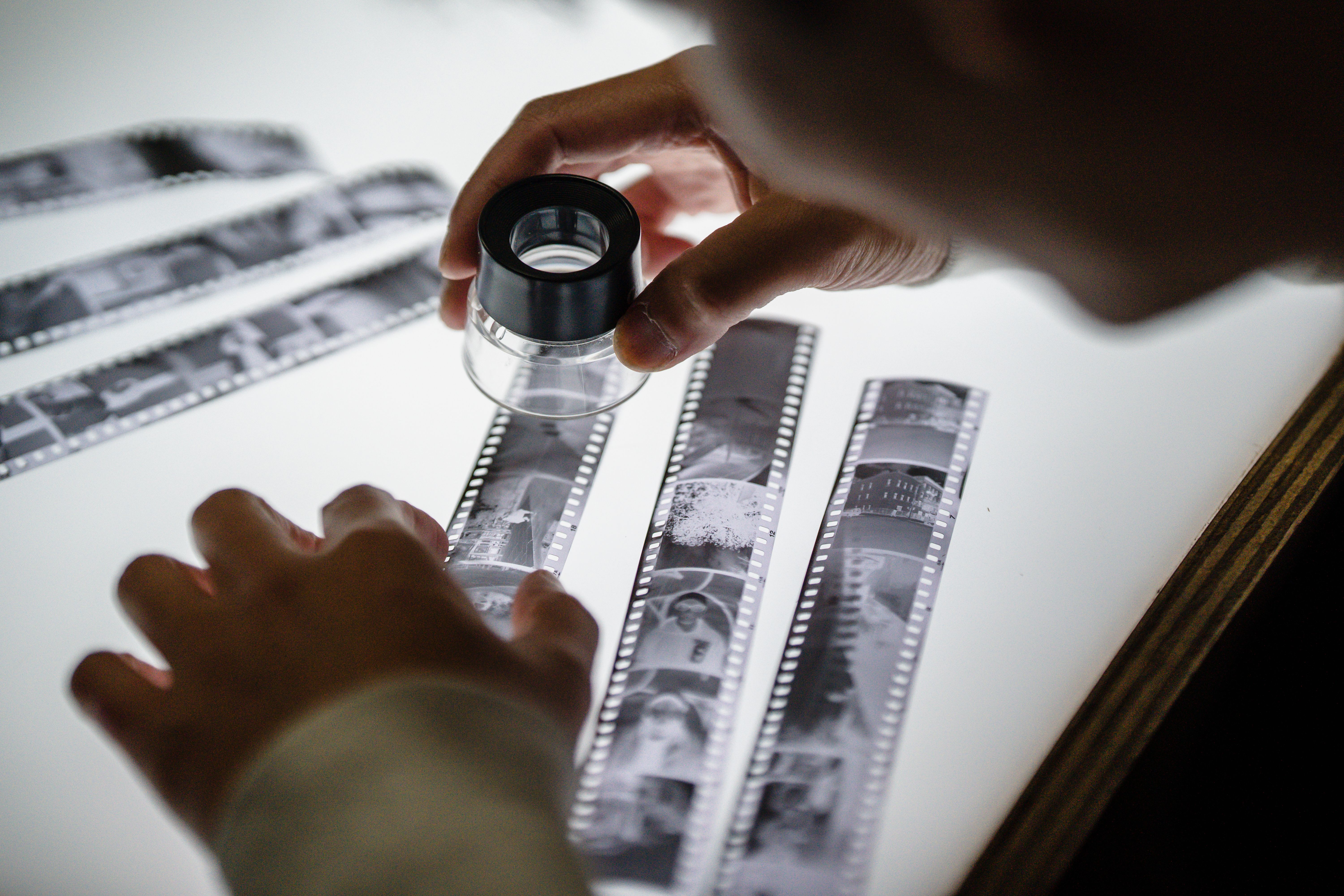 Close-up of a man examining an undeveloped film roll