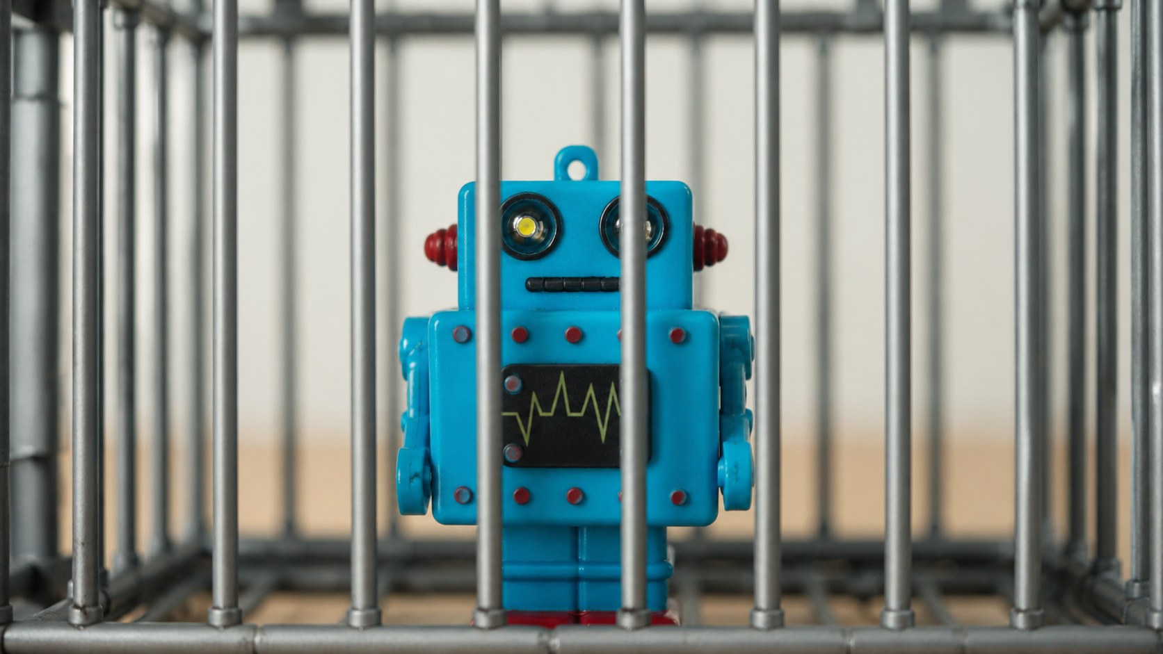 A robot behind bars, rendered as a cautionary illustration of AI under constraint
